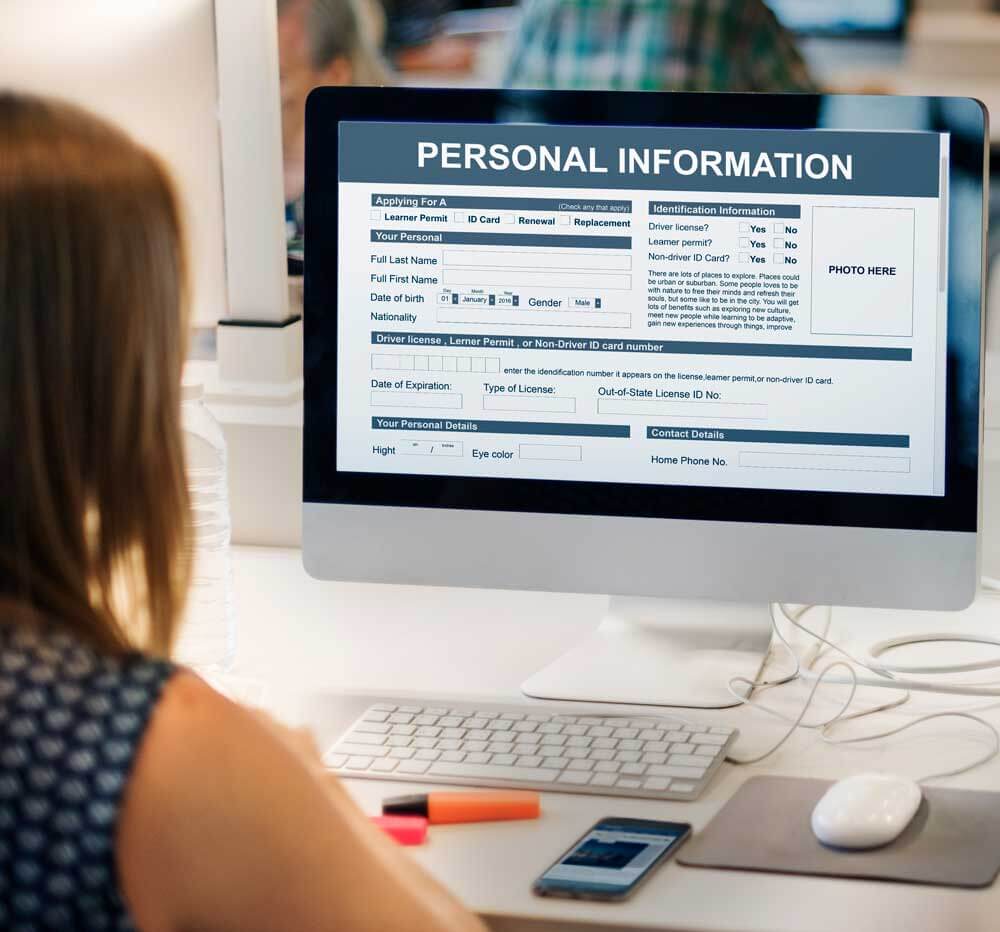 woman at computer entering personal information